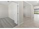 Neutral bedroom boasts plush carpeting and a modern design with a view of the entryway and living area at 2731 Winding Creek Trl, North Port, FL 34289