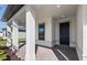 Covered front entryway showing the front door and brick surface with white columns at 2731 Winding Creek Trl, North Port, FL 34289