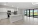 Kitchen with white cabinets, stainless steel appliances, and large glass doors to outside at 2731 Winding Creek Trl, North Port, FL 34289