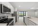 Kitchen with stainless steel appliances and a view out to the yard at 2731 Winding Creek Trl, North Port, FL 34289