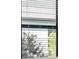 Close-up of a window with blinds at 2731 Winding Creek Trl, North Port, FL 34289