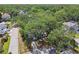 Beautiful aerial view of a property showcasing the mature trees and proximity to surrounding neighborhood and foliage at 3202 W Coachman Ave, Tampa, FL 33611