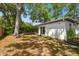 The backyard features lush greenery and a small deck, offering a private and serene outdoor space at 3202 W Coachman Ave, Tampa, FL 33611