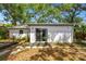 Backyard featuring a sliding glass door, patio and stepping stone details at 3202 W Coachman Ave, Tampa, FL 33611