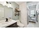 Shiplap accent wall bathroom with modern vanity, open shelving and adjacent linen storage area at 3202 W Coachman Ave, Tampa, FL 33611
