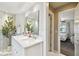 Bright bathroom with double marble vanity, soaking tub, glass shower and view of bedroom at 3202 W Coachman Ave, Tampa, FL 33611
