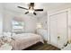 Bedroom showcasing a ceiling fan, light-colored walls, and a closet for storage at 3202 W Coachman Ave, Tampa, FL 33611