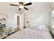 Bedroom featuring ceiling fan and light-colored walls, providing a cozy ambiance at 3202 W Coachman Ave, Tampa, FL 33611