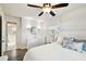 Light bedroom featuring a ceiling fan, wood-look floors, and bathroom access providing a luxurious feel at 3202 W Coachman Ave, Tampa, FL 33611