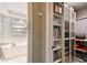 Hallway storage and adjacent luxurious bathroom features a freestanding soaking tub and bright window views at 3202 W Coachman Ave, Tampa, FL 33611