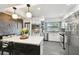Bright and airy kitchen with white cabinets, stainless steel appliances, island with seating, and stylish backsplash at 3202 W Coachman Ave, Tampa, FL 33611