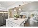 Open-concept living room flows from kitchen with stainless steel appliances and bright natural light at 3202 W Coachman Ave, Tampa, FL 33611