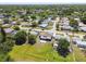 Aerial view showcasing the neighborhood, backyard, and home layout at 3257 Masonville Loop, Holiday, FL 34691