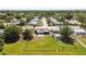 Single-Gathering home featuring a large fenced backyard, including an outdoor fire pit in a serene, tree-lined neighborhood at 3257 Masonville Loop, Holiday, FL 34691