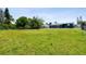 Expansive backyard featuring a lush lawn, perfect for outdoor activities and enjoying the surrounding greenery at 3257 Masonville Loop, Holiday, FL 34691