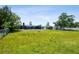 Spacious backyard with fencing and mature trees surrounding the property at 3257 Masonville Loop, Holiday, FL 34691