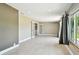Spacious basement area featuring tile floors, a large window, and French doors at 3257 Masonville Loop, Holiday, FL 34691
