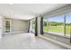 Bright basement with tile floors, large sliding windows, and access to the outdoors at 3257 Masonville Loop, Holiday, FL 34691