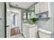 Bathroom featuring modern vanity, with view of the entry hall and view of another room at 3257 Masonville Loop, Holiday, FL 34691