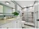 Updated bathroom featuring a tiled shower with rainfall shower head and updated vanity at 3257 Masonville Loop, Holiday, FL 34691