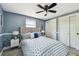 Bedroom features an upholstered headboard, patterned bedding, and double door closet at 3257 Masonville Loop, Holiday, FL 34691