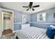 Bedroom featuring a patterned comforter, accent wall and en suite closet at 3257 Masonville Loop, Holiday, FL 34691