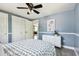 Bedroom featuring view into the hallway, double closet, and a decorative painting at 3257 Masonville Loop, Holiday, FL 34691