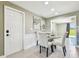 Cozy dining area featuring a glass table, elegant chairs, and stylish wall decor at 3257 Masonville Loop, Holiday, FL 34691