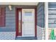 Close-up of the home's front door, showcasing the entrance with sidelight and hardware at 3257 Masonville Loop, Holiday, FL 34691