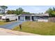 The home has solar panels, an attached garage, and a well-maintained front lawn at 3257 Masonville Loop, Holiday, FL 34691