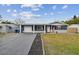 Charming single-story home with an attached carport and meticulously maintained front yard at 3257 Masonville Loop, Holiday, FL 34691