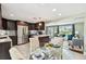 Modern kitchen open to the dining and living areas, with stainless appliances and a granite island at 3257 Masonville Loop, Holiday, FL 34691