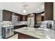Elegant kitchen boasts stainless steel appliances, granite counters, and mosaic backsplash at 3257 Masonville Loop, Holiday, FL 34691