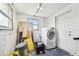 Laundry room with a newer model washer and dryer with space for additional storage at 3257 Masonville Loop, Holiday, FL 34691
