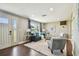 Bright living room showcasing hardwood floors, large windows, and comfortable furnishings at 3257 Masonville Loop, Holiday, FL 34691