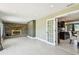 Open living room with fireplace and an open door to the modern kitchen at 3257 Masonville Loop, Holiday, FL 34691