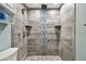 This shower features overhead showerhead, built-in shelves, and decorative mosaic-style tile at 3257 Masonville Loop, Holiday, FL 34691