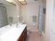 Well-lit bathroom featuring a single sink vanity, a toilet, and a shower with tiled floor at 337 Woodlake Wynde, Oldsmar, FL 34677