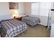 Cozy bedroom featuring twin beds, soft lighting and neutral tones at 337 Woodlake Wynde, Oldsmar, FL 34677