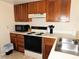 Functional kitchen featuring wooden cabinets, white countertops, and essential appliances for everyday cooking at 337 Woodlake Wynde, Oldsmar, FL 34677