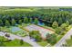 Aerial shot of basketball and tennis courts in an idyllic community surrounded by lush foliage at 3810 Darston St, Palm Harbor, FL 34685