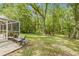 The backyard features a bench and table next to the screened-in lanai, offering a relaxing outdoor space at 3810 Darston St, Palm Harbor, FL 34685