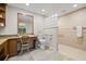 Bright bathroom with granite counters, stone floors, glass block wall, and accessible features at 3810 Darston St, Palm Harbor, FL 34685