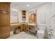 Bathroom showcasing a vanity with granite countertops, a toilet, and linen storage at 3810 Darston St, Palm Harbor, FL 34685