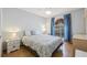 Bright bedroom with hardwood floors, a ceiling fan, and a stained glass window at 3810 Darston St, Palm Harbor, FL 34685