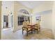 Bright dining area featuring tile floors, a large arched window, and views of the front courtyard at 3810 Darston St, Palm Harbor, FL 34685