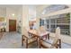 Cozy dining area with tile flooring, bright lighting, and an adjacent view of the kitchen at 3810 Darston St, Palm Harbor, FL 34685