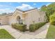 Beautiful angle view of the home with desert landscaping, neutral stucco exterior and a charming barrel tile roof at 3810 Darston St, Palm Harbor, FL 34685