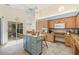 Bright kitchen with wood cabinets, granite countertops, an island with seating, and stone flooring at 3810 Darston St, Palm Harbor, FL 34685