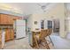 Bright kitchen with wood cabinets, granite countertops, an island with seating, and stone flooring at 3810 Darston St, Palm Harbor, FL 34685